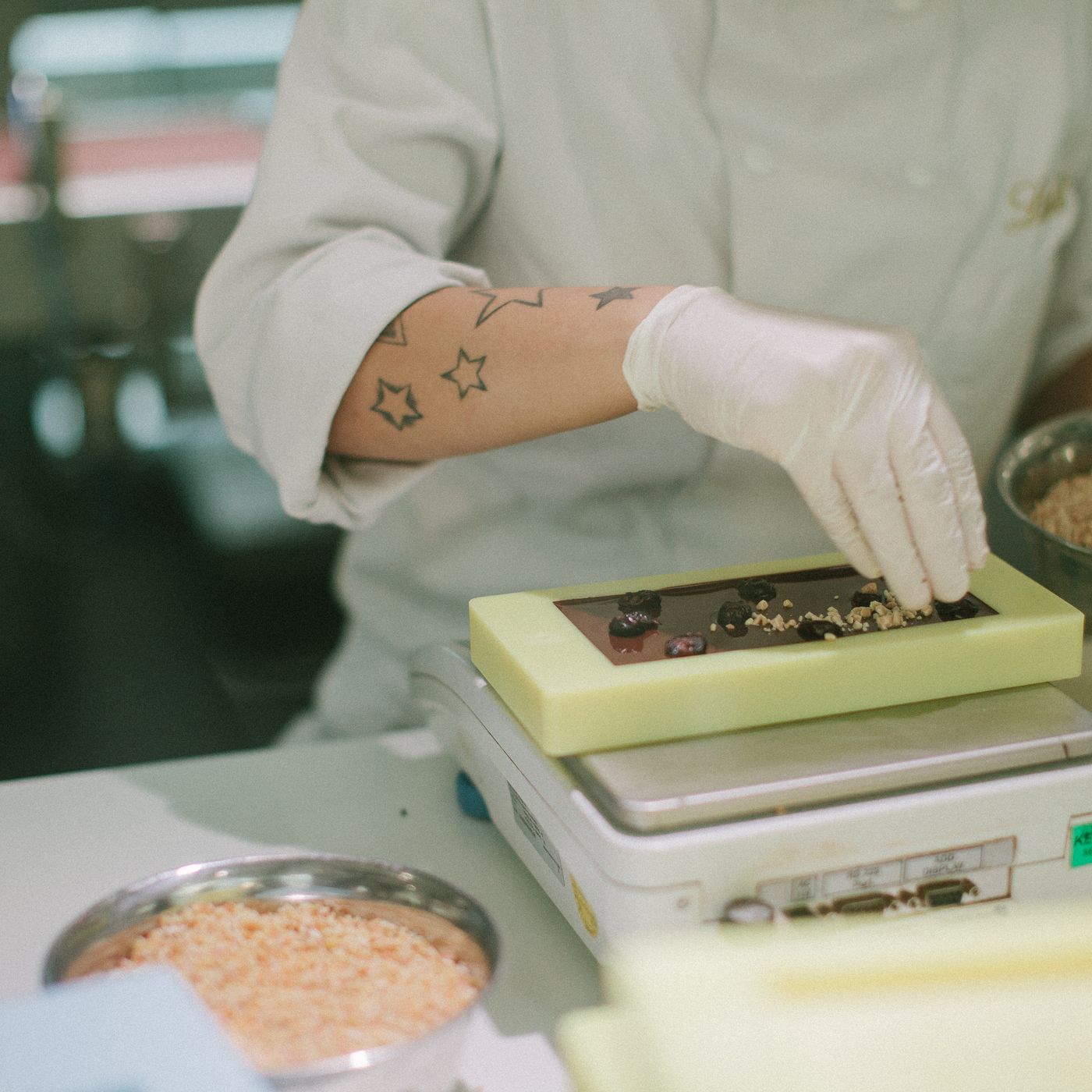 Confectioner finishing a chocolate bar in a production kitchen