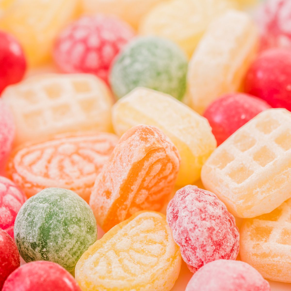 Close-up of assorted hard candies dusted with sugar